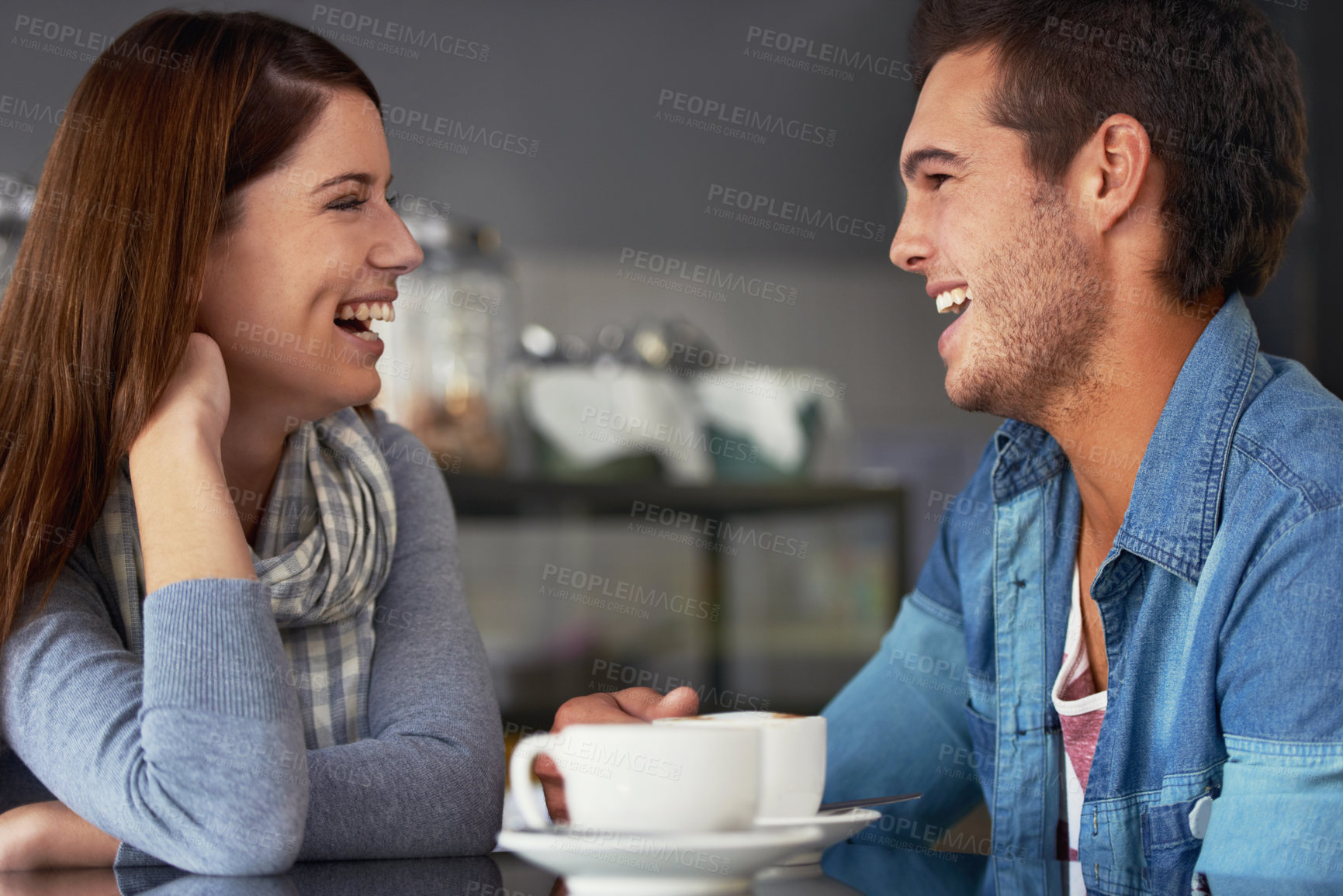 Buy stock photo A loving young couple at a coffee shop together