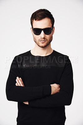 Buy stock photo Sunglasses, fashion and man in studio with crossed arms for confidence, pride and stylish clothing. Portrait, style and serious male person with funky, cool and trendy eyewear on white background
