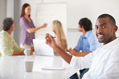 Buy stock photo Portrait, business and black man at table in office, coworking or presentation in startup. Face, smile and creative writer at desk, entrepreneur or African professional employee with pen in meeting