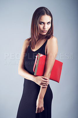 Buy stock photo Studio shot of an elegantly dressed young woman against a gray background