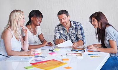 Buy stock photo A creative team brainstorming in the boardroom together!