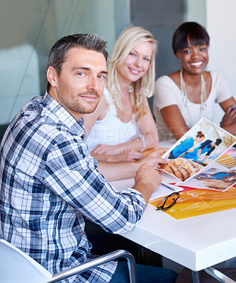 Buy stock photo Portrait, man and creative team for brainstorming in office with picture, file and color for article planning. Diversity, male editor or writer with woman for meeting, discussion or collaboration