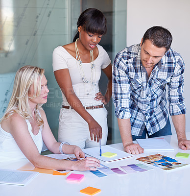 Buy stock photo Creative, woman and team with discussion in boardroom for color, swatch and design for magazine layout. Diverse group, female leader and guidance for planning, brainstorming and sticky note for idea
