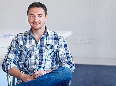 Buy stock photo Chair, entrepreneur or portrait of happy man with smile, small business or confidence in office. Sitting, male designer or employee with pride at startup job, career or company alone by mockup space