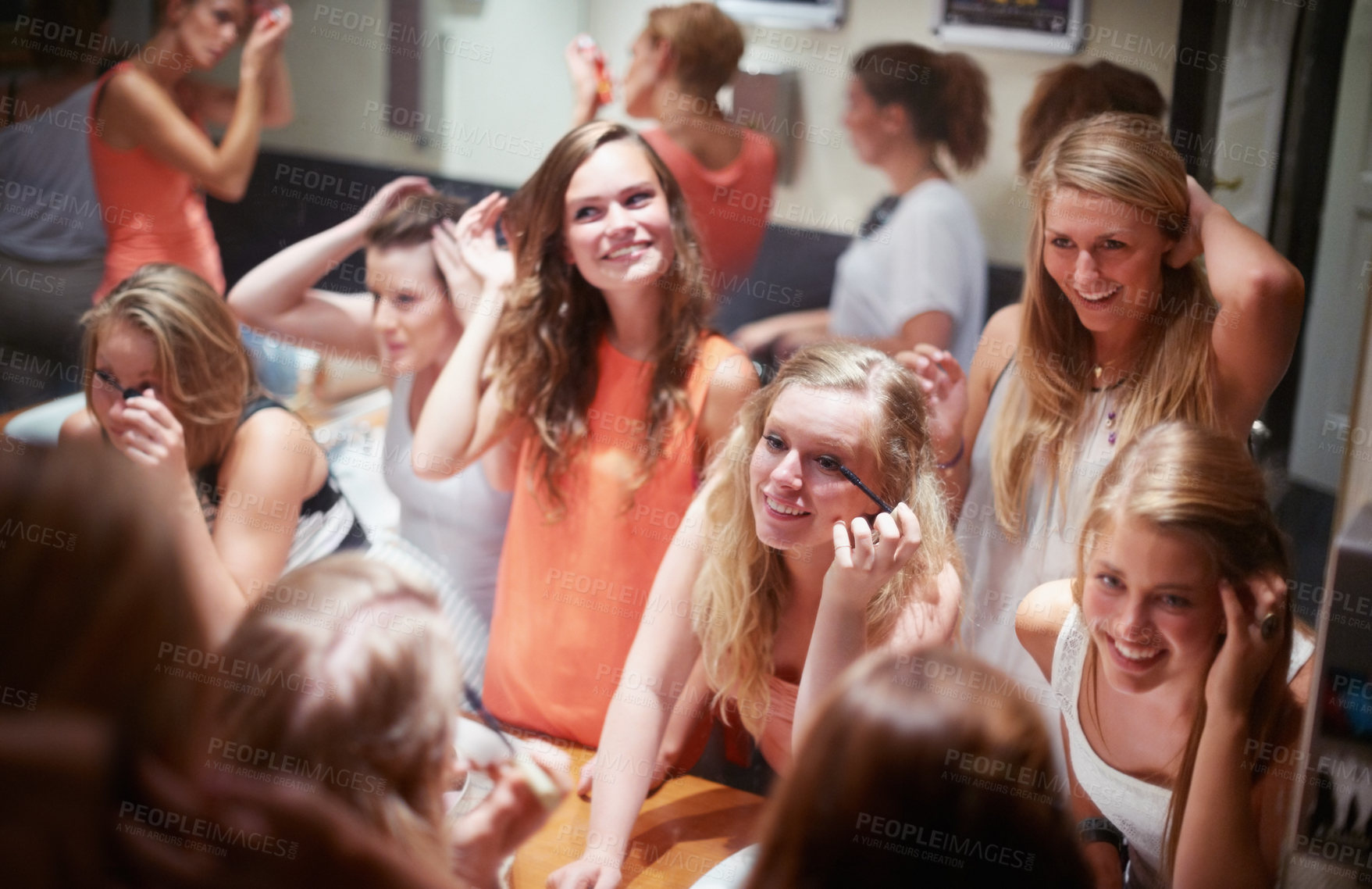 Buy stock photo A group of friends freshening up and applying makeup in a nightclub's bathroom. This concert was created for the sole purpose of this photo shoot, featuring 300 models and 3 live bands. All people in this shoot are model released.