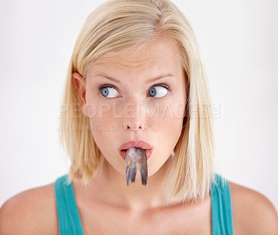 Buy stock photo Face, woman and eating tail of fish with surprise and shock on white background of studio. Crazy, diet and person with taste of weird seafood, cuisine and confused with gross or strange food in mouth