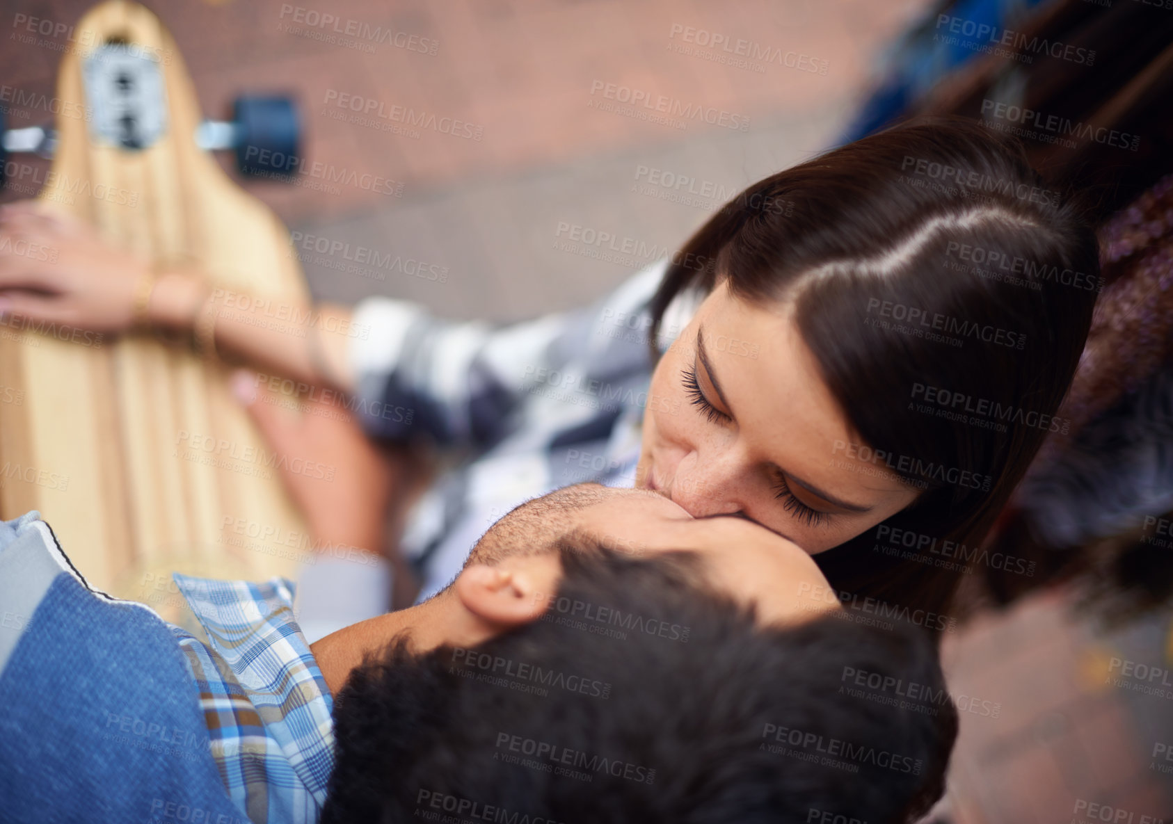 Buy stock photo Couple, skateboard and kissing with above, happy and excited to learn together and romantic relationship. Cape town, fun and hobby with boyfriend and girlfriend in street, helping and dating