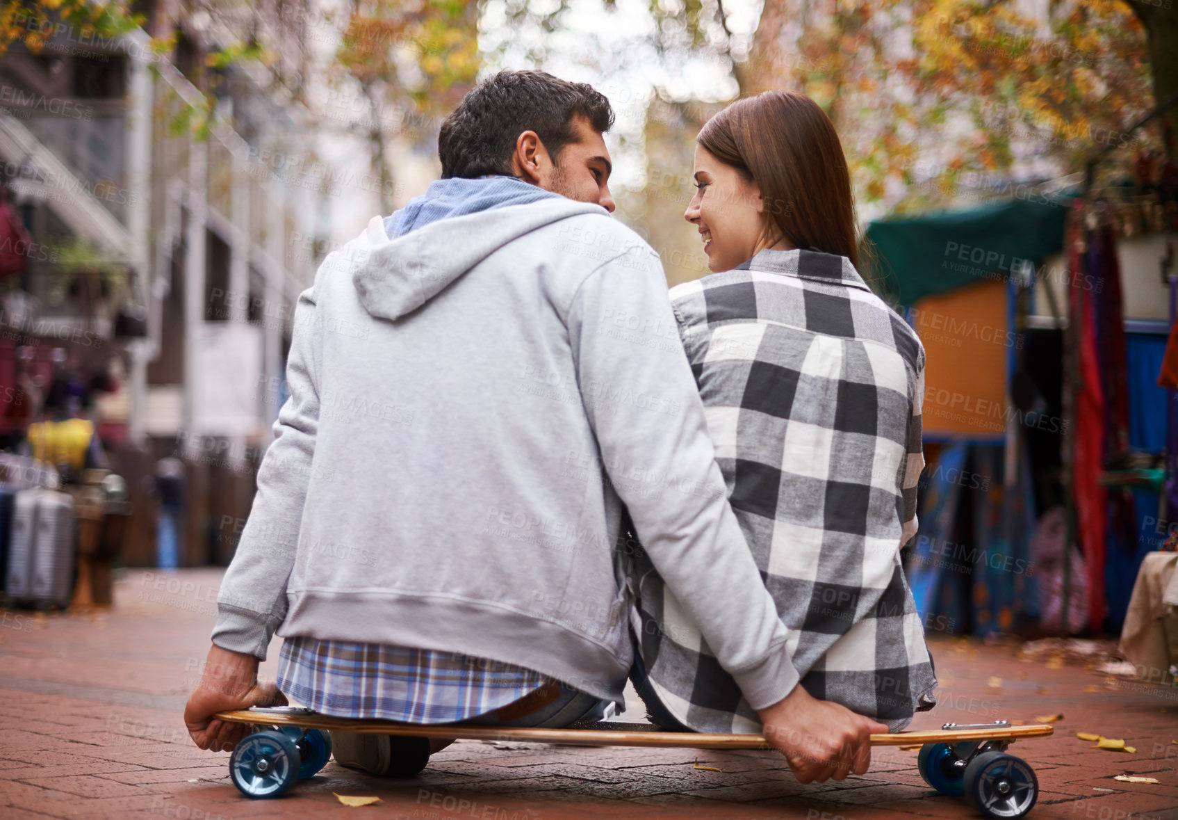 Buy stock photo Couple, travel on skateboard and outdoor in city, happy and conversation with partner, learn together and relationship. Cape town, fun and hobby with boyfriend and girlfriend in street, love or date