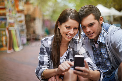 Buy stock photo City, smile and couple with a cellphone, internet and social media with texting, digital app or meme. New York, man or woman with a smartphone, mobile user or connection with network, joy or marriage