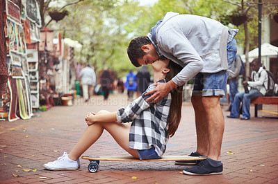 Buy stock photo Couple, sitting on skateboard and kiss in city, happy and romantic partner, learn together and relationship. Cape town, fun and hobby with boyfriend and girlfriend in street, love and dating