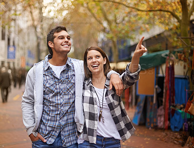 Buy stock photo Happy, walking and couple pointing at city destination, morning trip and tour of urban Paris for outdoor adventure. Love, travel and bonding man, woman or relax people gesture at street view