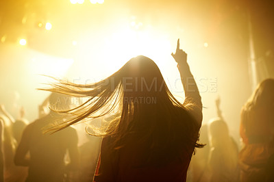 Buy stock photo Dance, music and back of woman at a concert, disco event or psychedelic trance festival. Night, energy and female person dancing or moving to a song with a yellow light at techno night club or party.