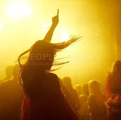 Buy stock photo Dance, rave and female person at a concert, disco event or psychedelic trance festival. Night, energy and woman dancing or moving to a song with a yellow light at techno night club or party with dj.