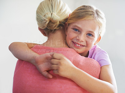 Buy stock photo Mother, girl and hug in portrait, bonding and love in childhood by single parent in studio. Daughter, mommy and caring together on white background, embracing and security or enjoying connection
