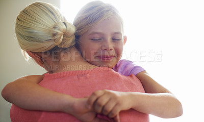 Buy stock photo A cute little girl hugging her mom with a happy expression
