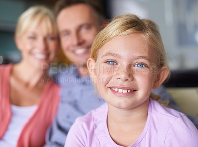 Buy stock photo Girl, smile and family portrait at home for bonding, security and love in childhood or happiness. Mother, father and daughter relaxing on vacation, parents and connection or care in relationship