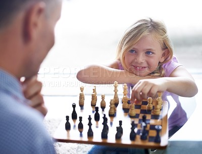 Buy stock photo Smile, child and father play chess in home, family bonding together or development. Happy girl, man and board game of strategy, challenge or entertainment of young kid in competition match in house