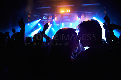 Buy stock photo A crowd of people watching a band play on stage at a nightclub