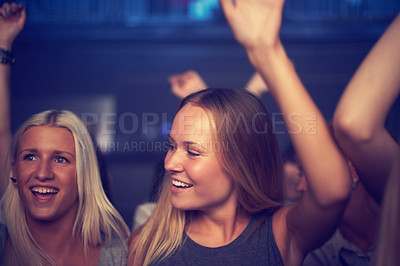 Buy stock photo Nightclub, women and happy at party with dancing for performance, entertainment and hands raised. Music festival, people and friends with disco, concert or audience on dance floor at social event