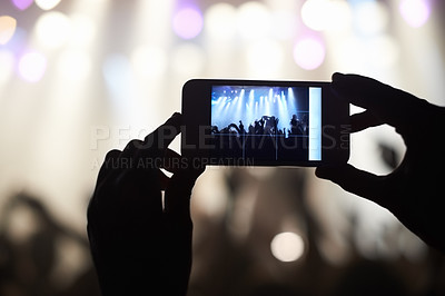 Buy stock photo A person filming their favourite band with a camera phone. This concert was created for the sole purpose of this photo shoot, featuring 300 models and 3 live bands. All people in this shoot are model released.