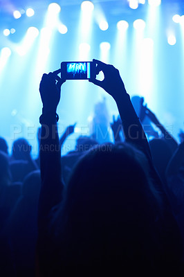 Buy stock photo A person filming their favourite band with a camera phone