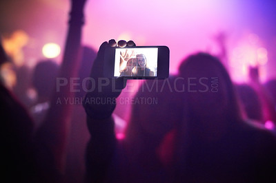 Buy stock photo Shot of a fan filming a concert on their camera. This concert was created for the sole purpose of this photo shoot, featuring 300 models and 3 live bands. All people in this shoot are model released.