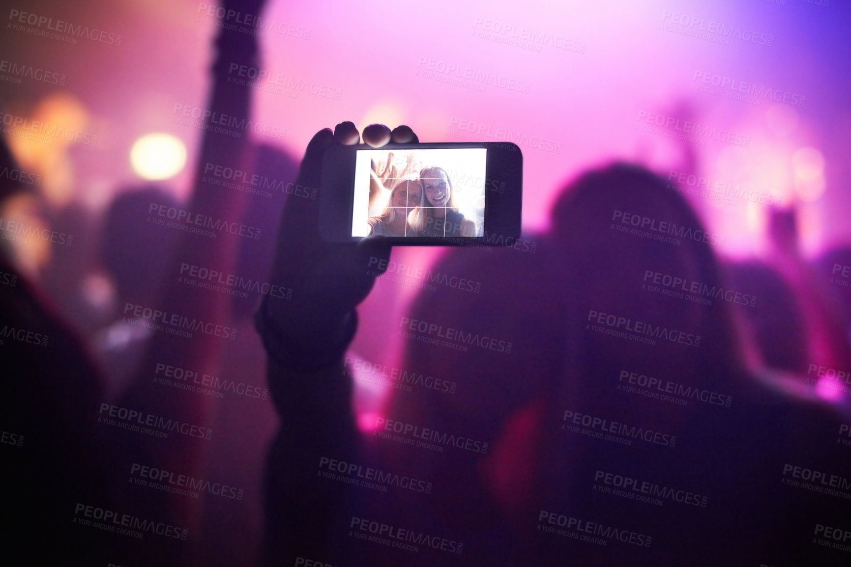 Buy stock photo Shot of a fan filming a concert on their camera. This concert was created for the sole purpose of this photo shoot, featuring 300 models and 3 live bands. All people in this shoot are model released.