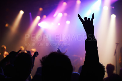 Buy stock photo Silhouette, concert and audience with rock or sign for music, party and rave festival with spotlight and dancing. Disco, dj event and performance with entertainment, crowd and rear view gesture