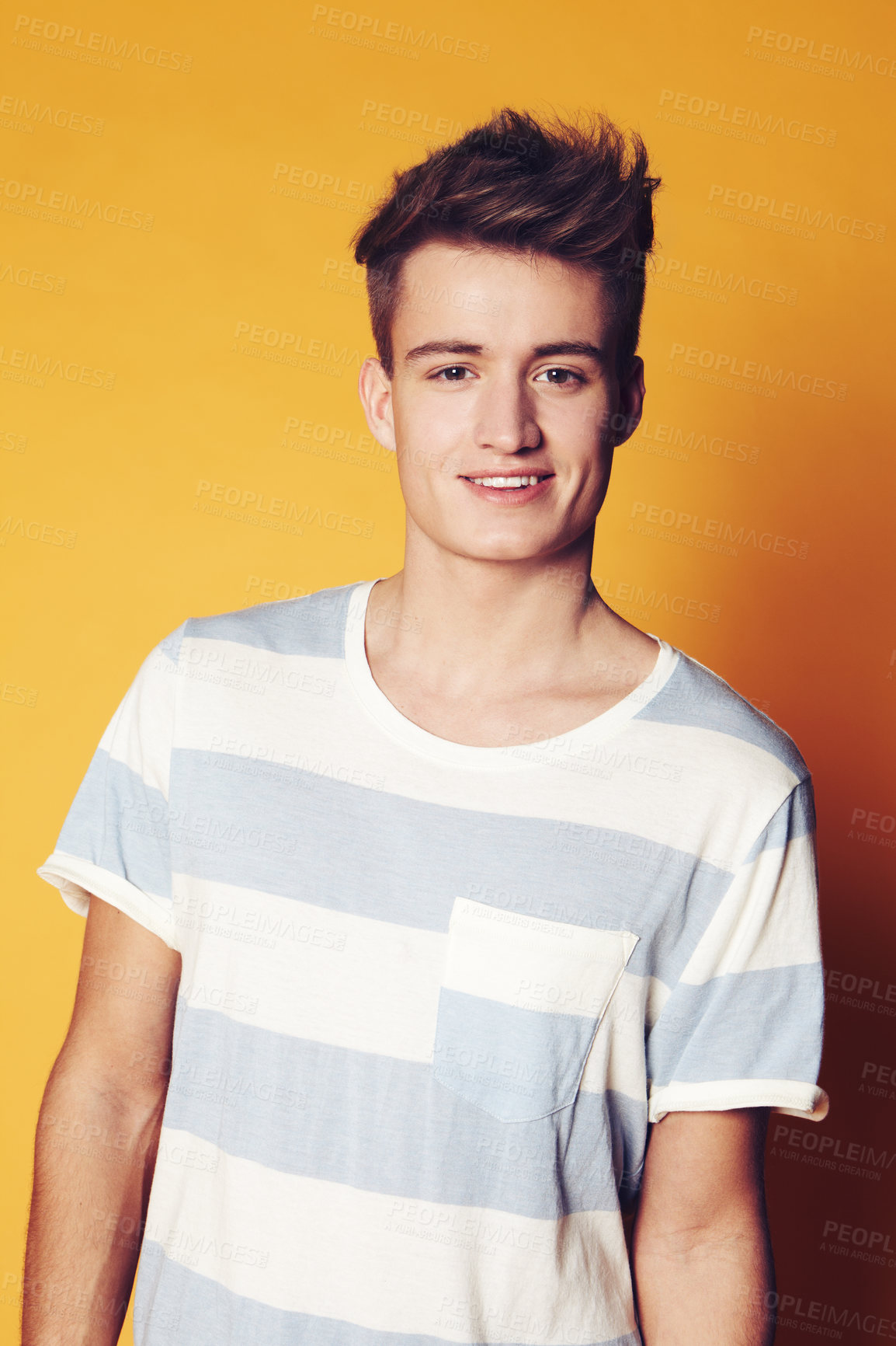 Buy stock photo Portrait, fashion and man with style, smile and confident guy on an orange studio background. Face, person and model with student, casual outfit and stylish clothes with gen z, t shirt and aesthetic