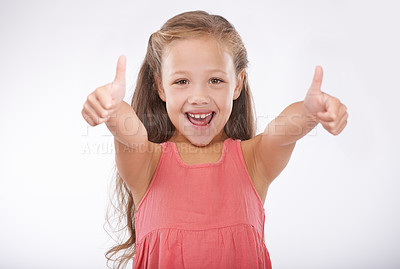 Buy stock photo Studio portrait of a cute young girl giving a thumbs-up to the camera