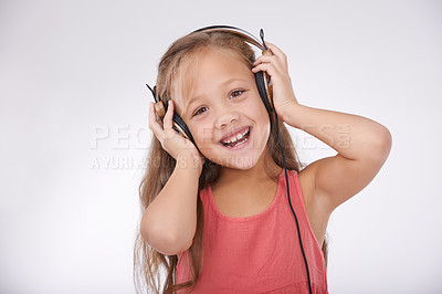 Buy stock photo Child, music and portrait of girl with headphones in studio for audio, subscription and streaming multimedia on white background. Excited kid listening to podcast, hearing sound and radio connection