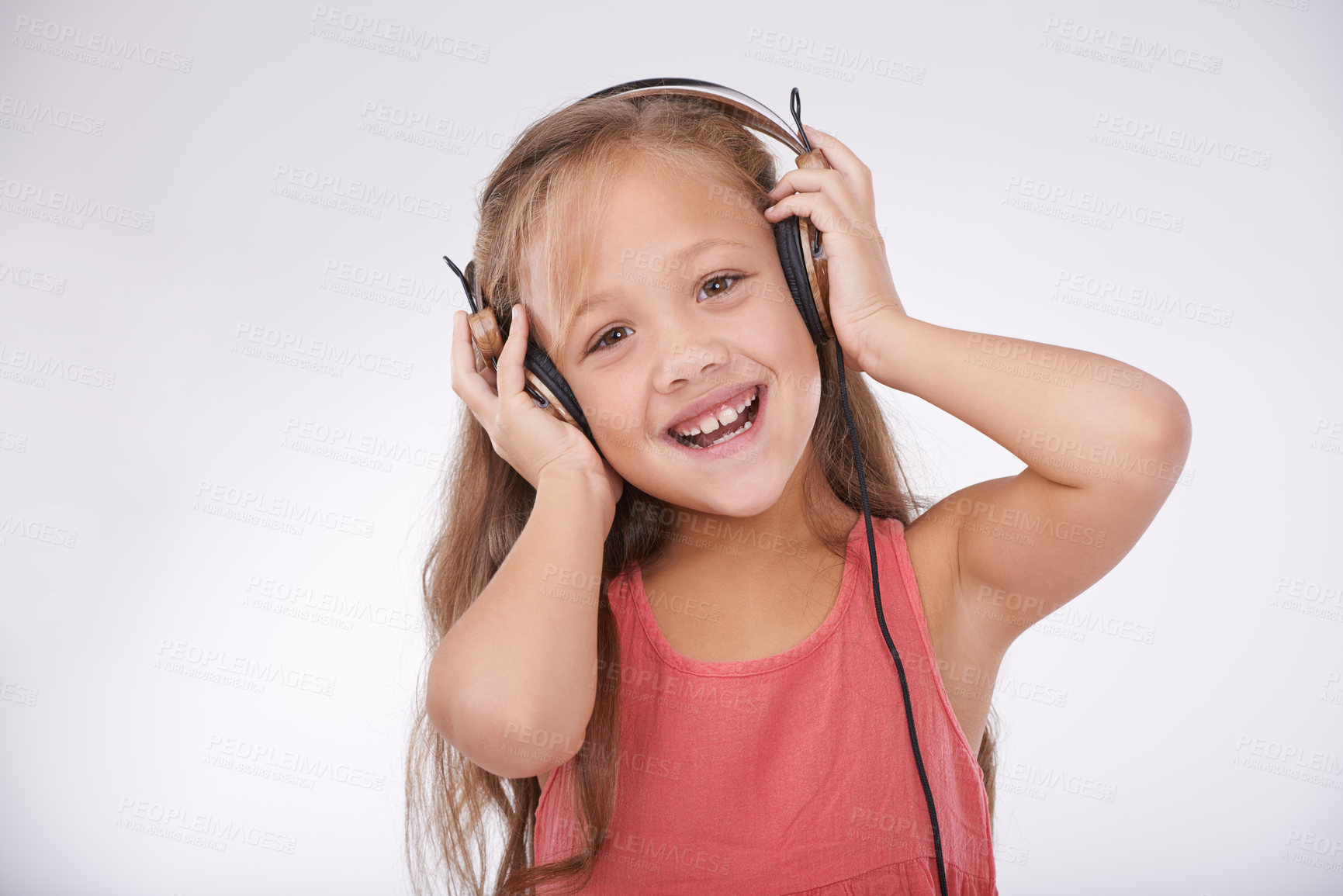 Buy stock photo Child, music and portrait of girl with headphones in studio for audio, subscription and streaming multimedia on white background. Excited kid listening to podcast, hearing sound and radio connection