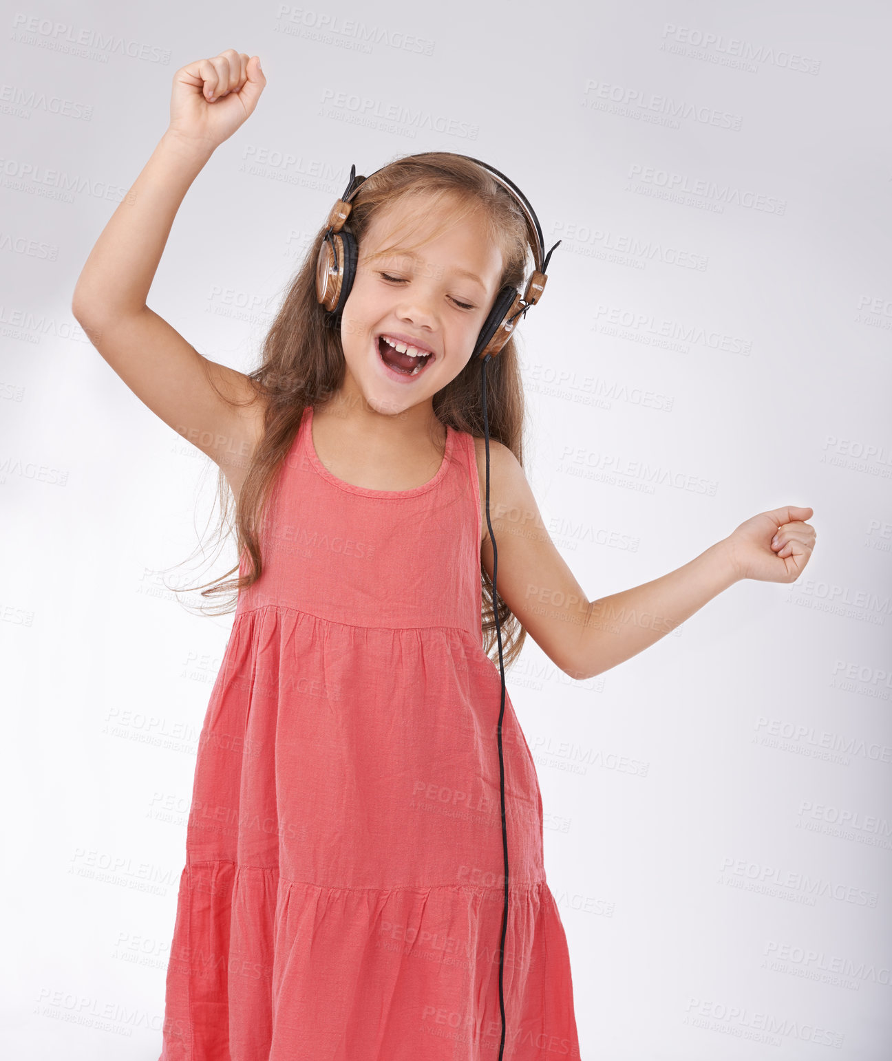 Buy stock photo Girl kid, dance and singing with headphones in studio for streaming audio, multimedia and celebration on white background. Excited young child with energy listening to music, hearing sound and radio