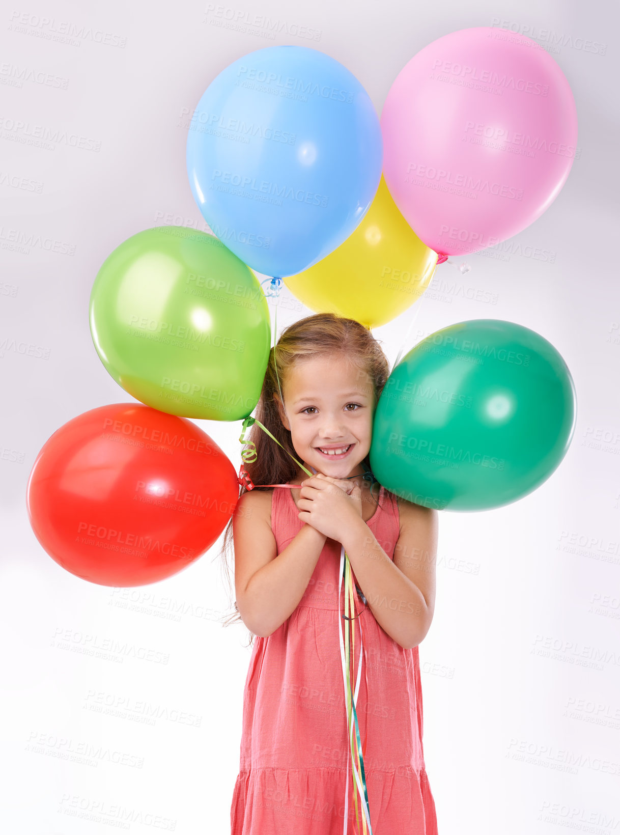 Buy stock photo Girl, child and birthday balloons in portrait, party decoration and smiling for milestone event in studio. Happy female person, inflatable accessory and joy on white background, playful and celebrate