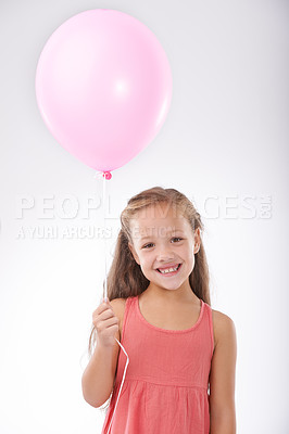 Buy stock photo Girl, child and balloon in portrait, party decoration and smiling for milestone event in studio. Happy female person, inflatable accessory and birthday joy on white background, playful and celebrate
