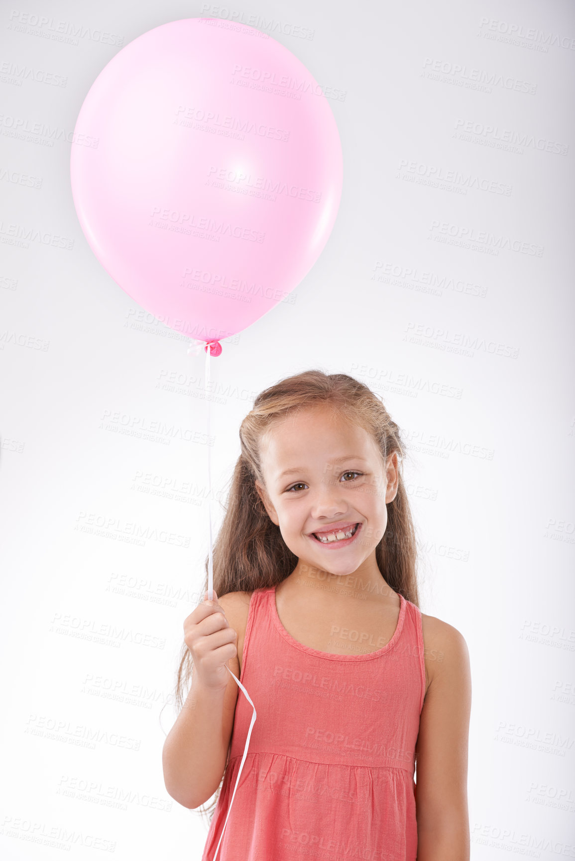 Buy stock photo Girl, child and balloon in portrait, party decoration and smiling for milestone event in studio. Happy female person, inflatable accessory and birthday joy on white background, playful and celebrate