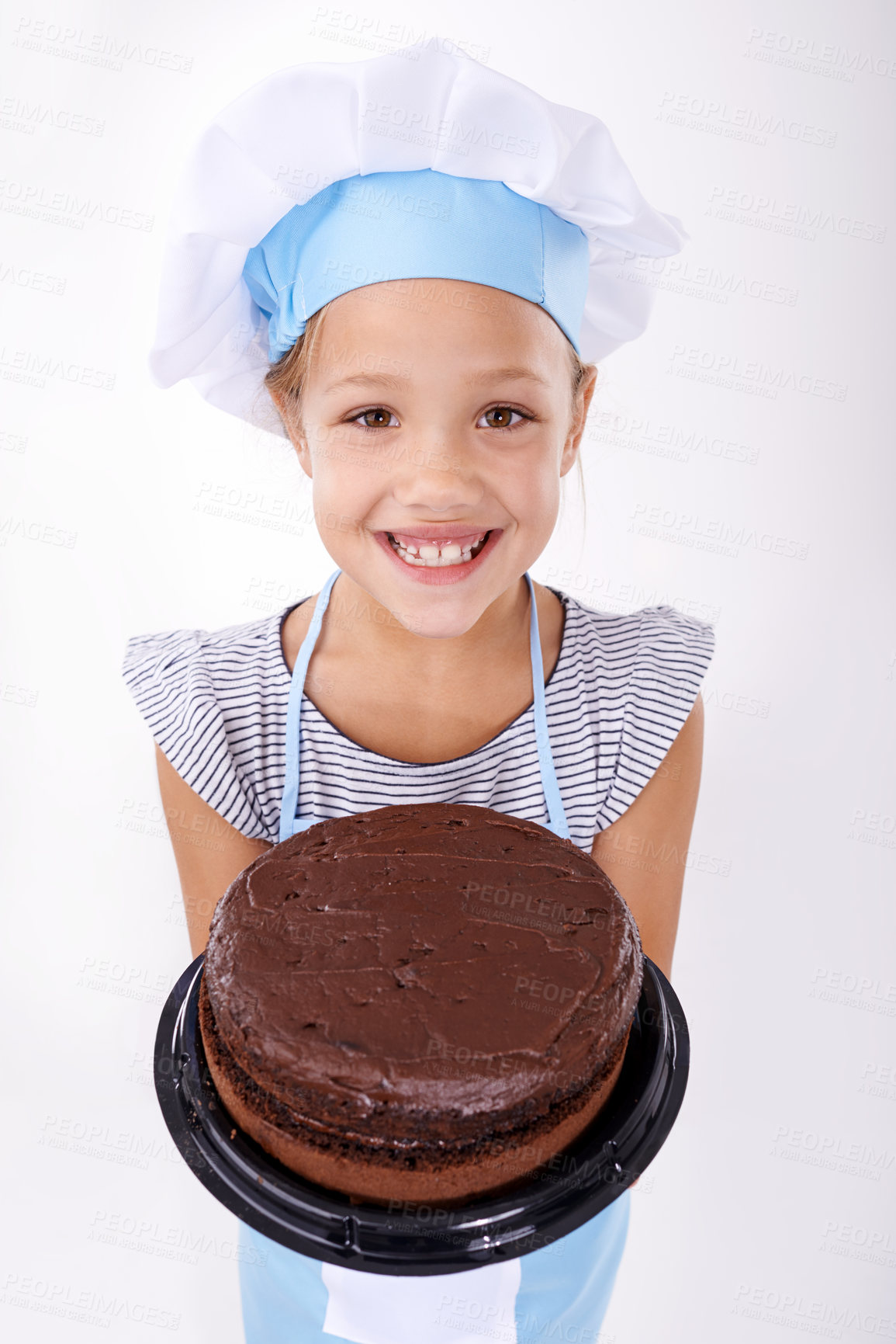 Buy stock photo Studio shot of a cute young girl wearing a chef's hat and holding up a chocolate cake