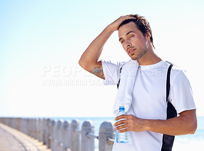 Buy stock photo Beach, fitness and man with water bottle, summer and exercise with wellness and peaceful. Person, seaside and guy with liquid and ideas with nature, thinking and workout with breathing and nutrition