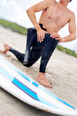 Buy stock photo Surfer, man stretching legs and surfboard on beach, fitness and extreme sport, ready for waves with travel and sand. Summer, wet suit and warm up, start surfing and nature with adventure outdoor