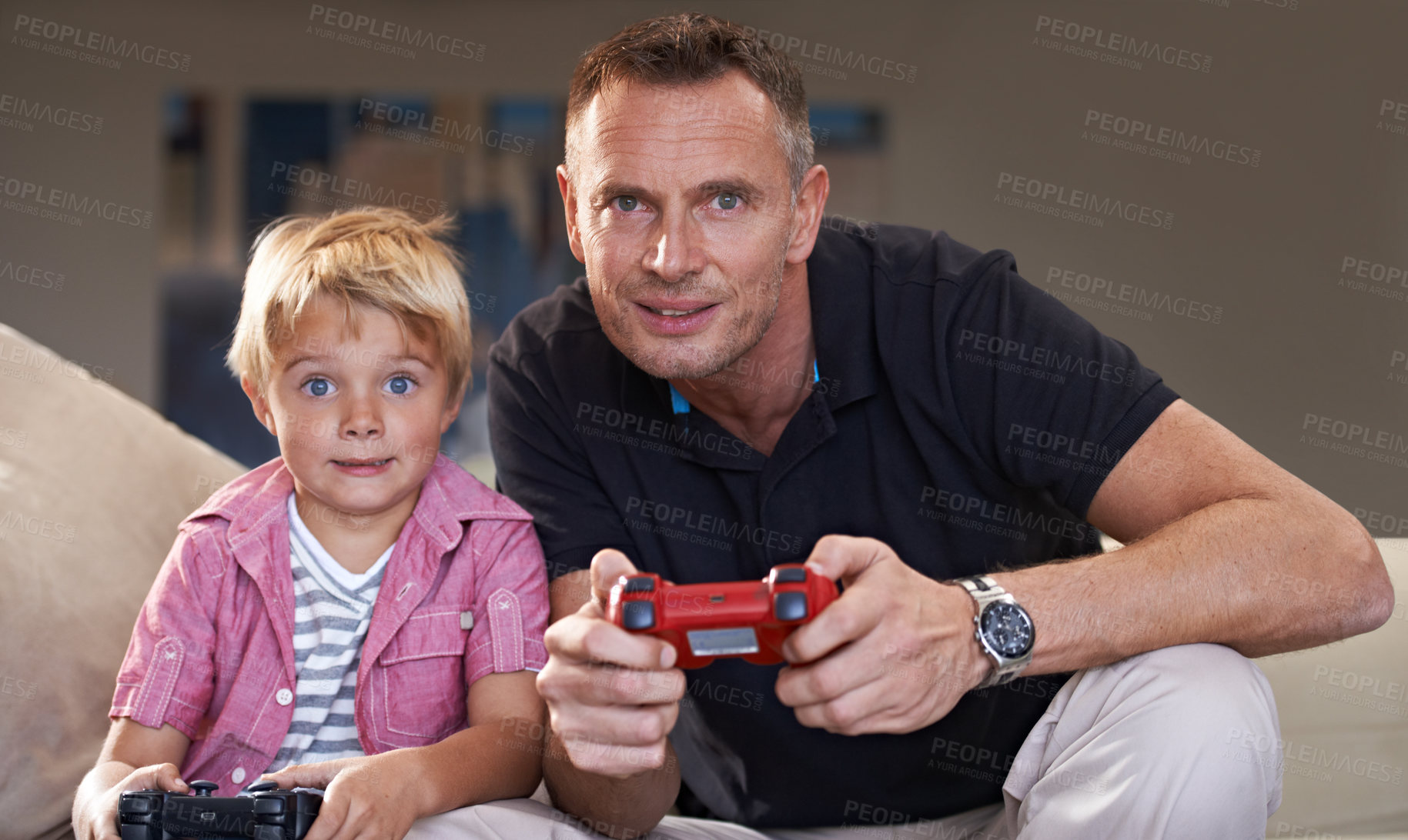 Buy stock photo Family, father and serious son gaming on sofa in living room of home together for love, bonding or competition. Video game, controller for next level and gamer dad with boy child in apartment