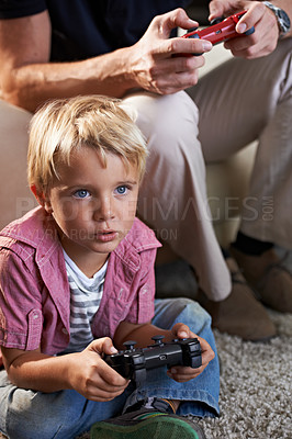 Buy stock photo Family, serious and boy child gaming on floor in living room of home with father for love, competition or child development. Video game, controller for next level and son gamer playing with dad
