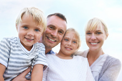 Buy stock photo A happy two generation family smiling while outdoors