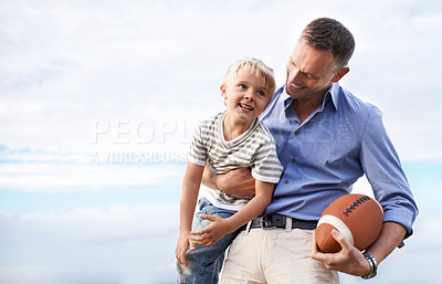 Buy stock photo Blue sky, football and father with young son on outdoor adventure, playful or excited mockup space. Relax, bonding together and family, happy child and dad on summer holiday for fun, game and smile.
