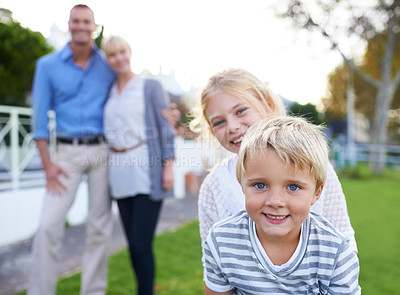 Buy stock photo A happy two generation family smiling while outdoors