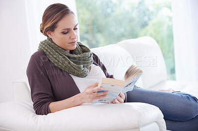 Buy stock photo Woman, book and reading on sofa to relax for story, novel and learning knowledge in living room at home. Lady, fiction books and break for studying literature, hobby or comfortable on couch in lounge