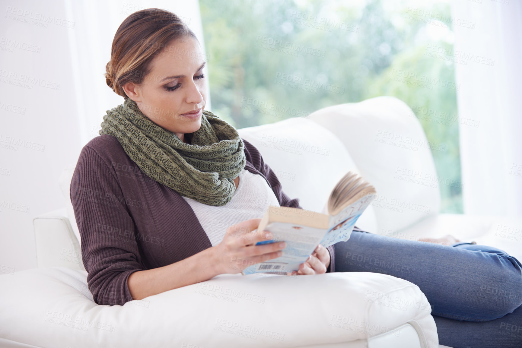 Buy stock photo Woman, book and reading on sofa to relax for story, novel and learning knowledge in living room at home. Lady, fiction books and break for studying literature, hobby or comfortable on couch in lounge