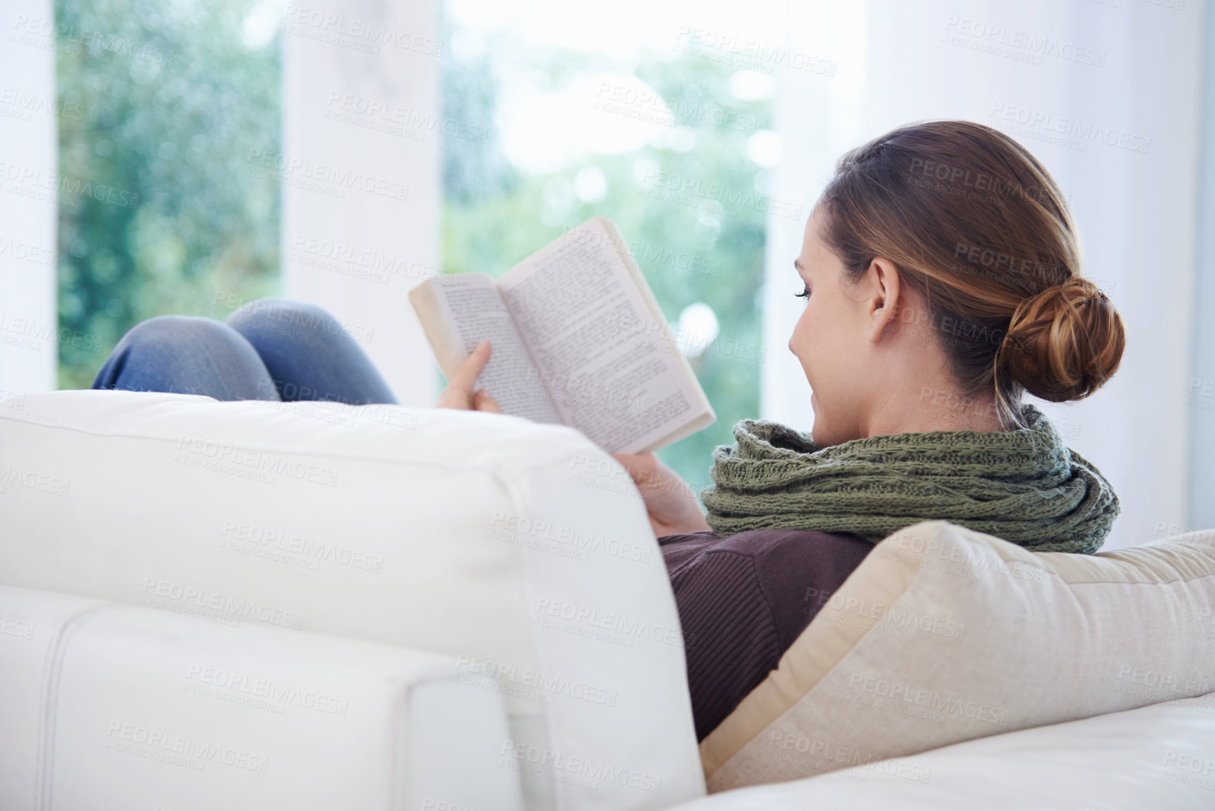 Buy stock photo Woman, book and reading in home from the back for story, novel and learning knowledge on sofa in living room. Lady, fiction books and relax on couch with literature, hobby and comfortable in lounge