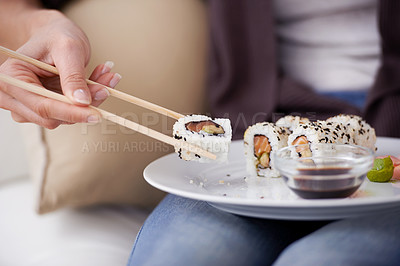 Buy stock photo Hands, sushi plate and chopsticks in home, closeup or eating for wellness, diet or meal with soy sauce. Hungry person, fish and dish at lunch, nutrition or snack for takeaway food, house or apartment