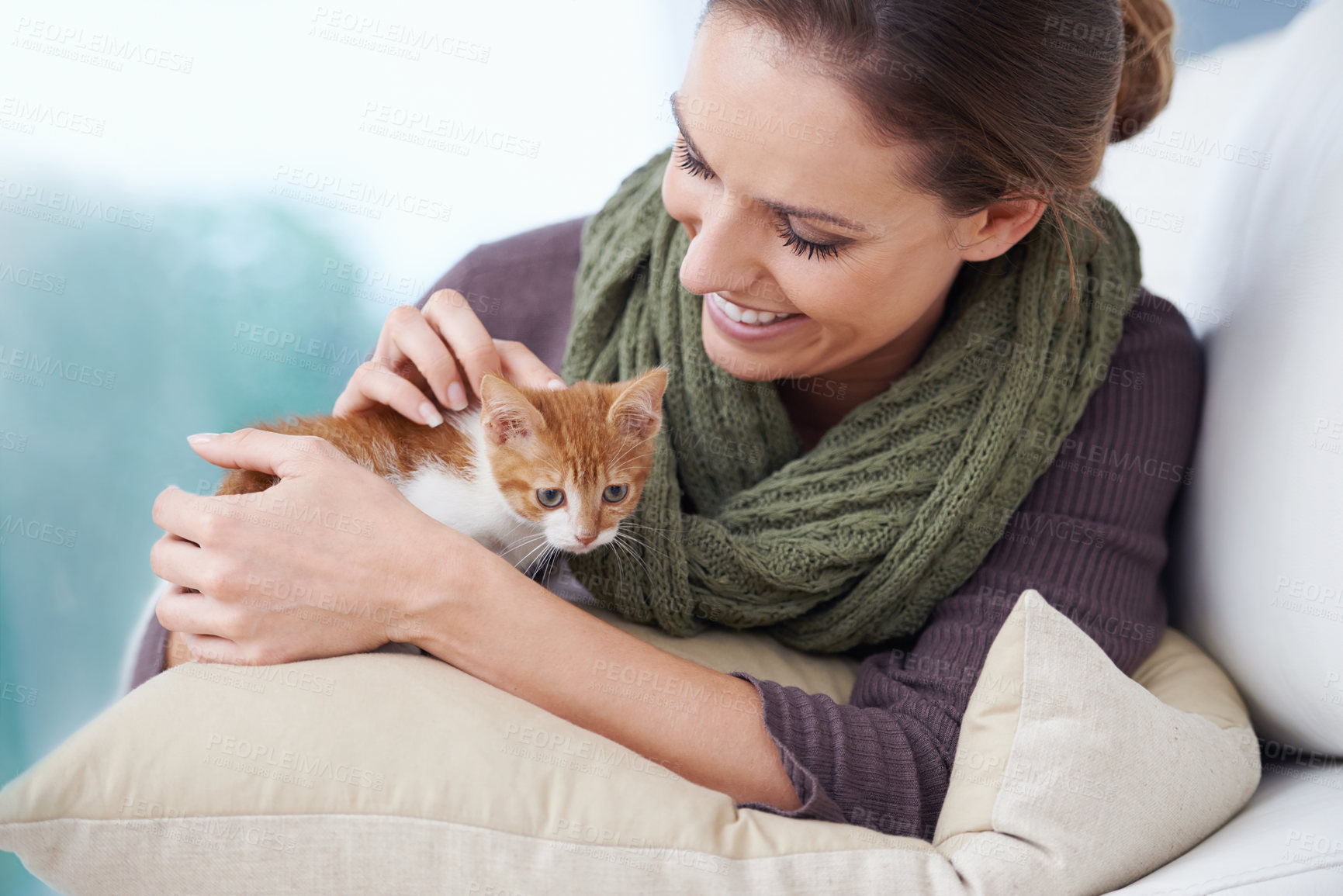 Buy stock photo Happy, sofa and woman with kitten in home for bonding, friendship and relax together in house. Animal care, pets and person with adorable, cute and young cat on couch for playing, affection and love