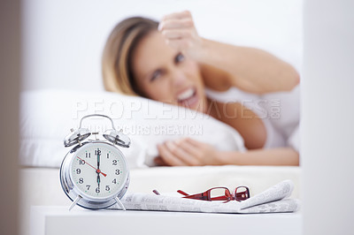 Buy stock photo Sleeping, anger and woman in bed with alarm for snooze, wake up and morning routine in home. Lazy, tired and person frustrated, angry and upset in bedroom for time, clock and ringing in apartment